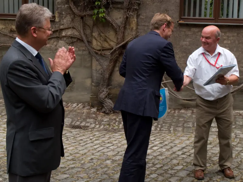 Janez Slatinsek hands over the book about Slovenia